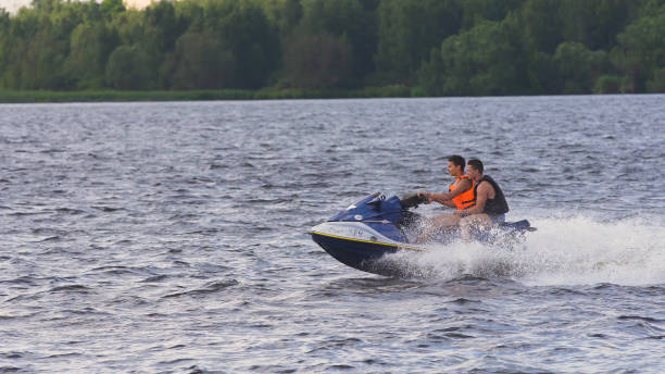 istock Riders on jet ski on lake 957703278
