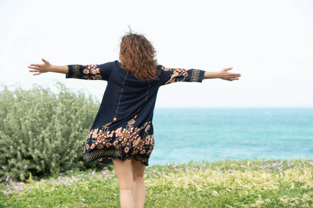 istock Woman runs happy in a meadow 957705420