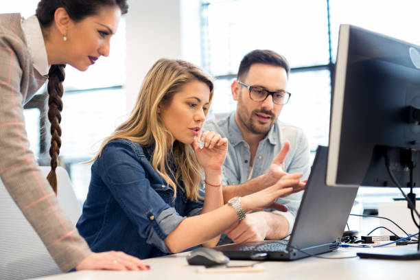 istock Group of business people and software developers working as a team in office 957707844