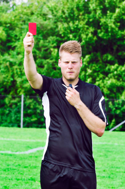 istock Sports referee shows red card after blowing his whistle 957708098