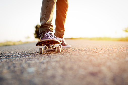 Closeup of teenager skateboarder legs