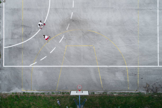 istock Drone view on two friends playing basketball 957712572