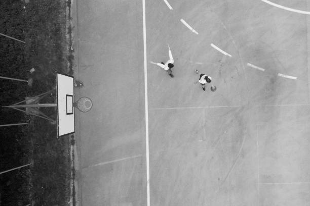 istock Drone view on two friends playing basketball 957712772