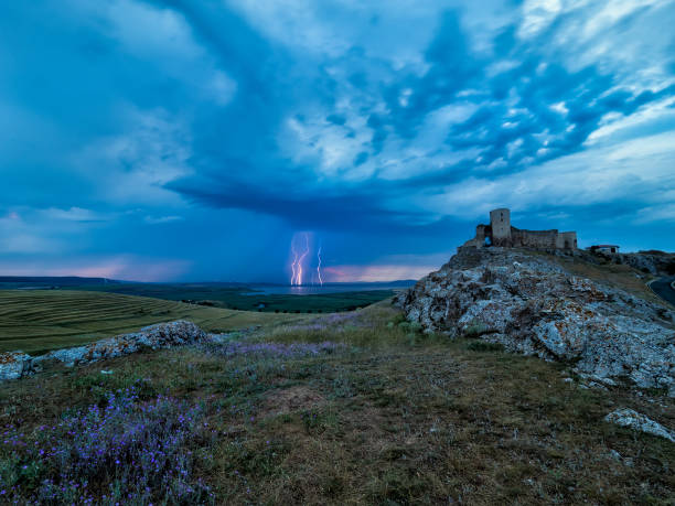 Thunderbolts,lightning on a cloudy evening blue sky over an old stronghold,citadel