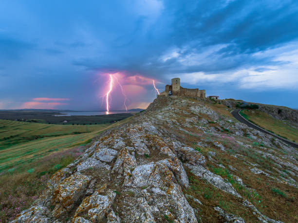 istock Thunderbolts,lightning on a cloudy evening blue sky over an old stronghold,citadel 957712916