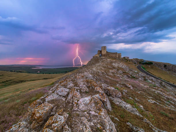istock Thunderbolts,lightning on a cloudy evening blue sky over an old stronghold,citadel 957712920