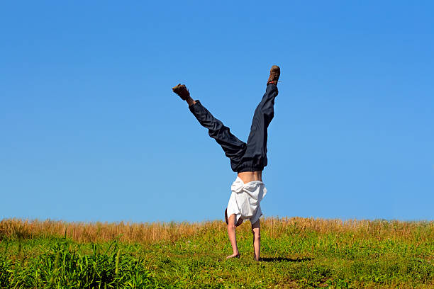 istock Teenager stand on hands 95771718