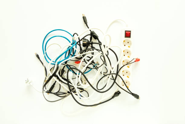 istock Computer cables, wires, chargers in a messy heap. Home electronic chaos concept, flat lay 957718430