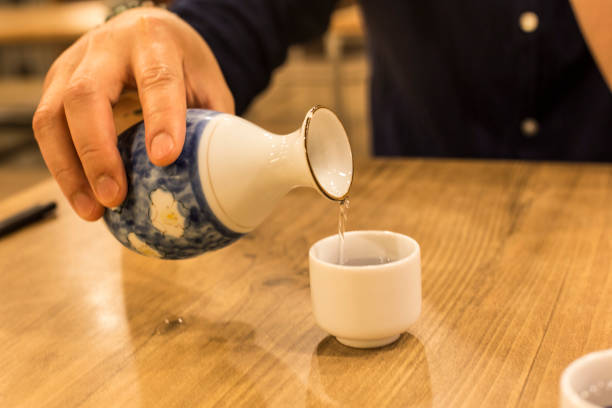 istock Prepared to drink sake on wood table(sake bottle and cups) 957724972