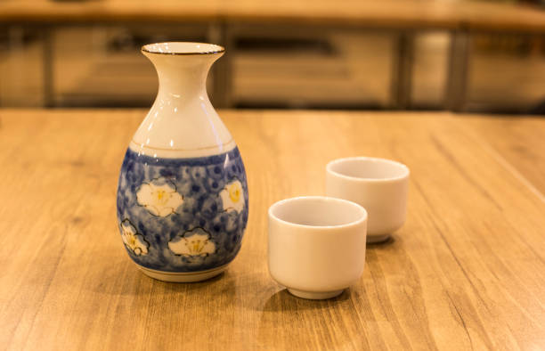 istock Prepared to drink sake on wood table(sake bottle and cups) 957725114