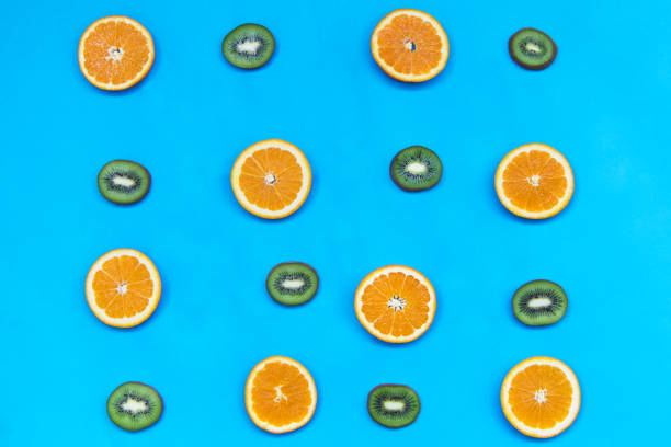 istock Kiwi and orange on the light blue background 957725636