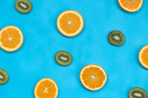 istock Kiwi and orange on the light blue background 957728024