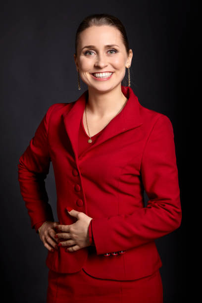 istock Cheerful Woman in a Red Skirt Suit 957729982