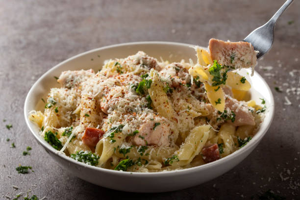 istock Italian pasta penne with chicken meat and bacon 957737396