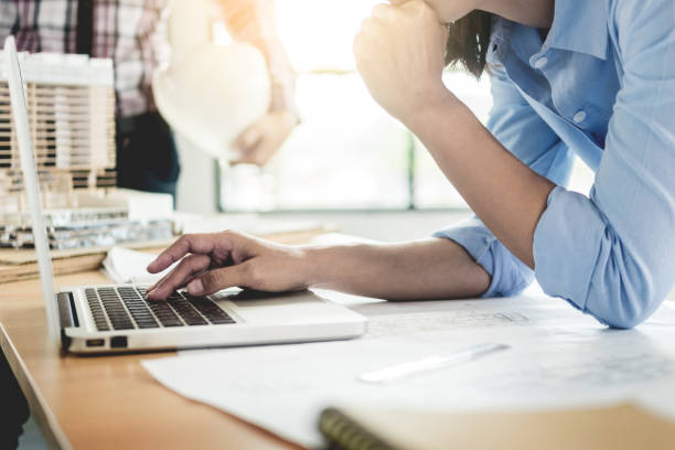 istock Midsection Of Businesswoman Using Laptop At Desk 957743942