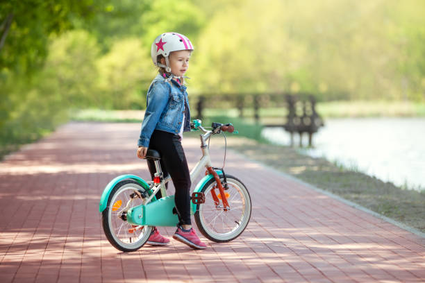 istock Cure little girl riding on bicycle 957743970