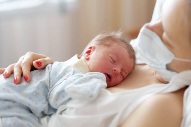 istock One day old newborn baby with mother 957751190