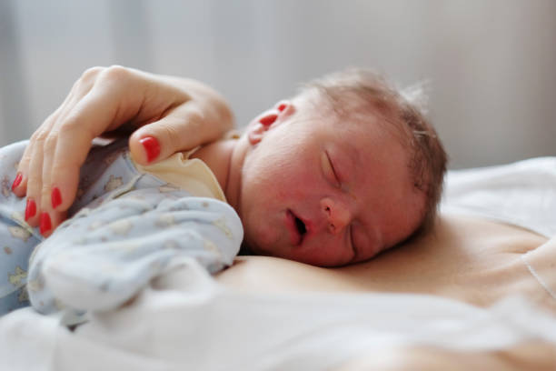 istock One day old newborn baby with mother 957751212