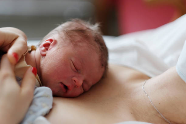 istock One day old newborn baby with mother 957751214