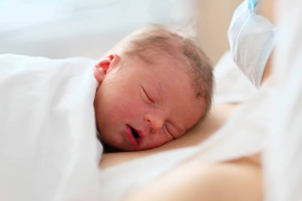 istock One day old newborn baby with mother 957751224