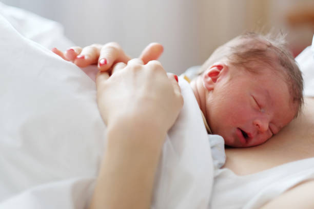 istock One day old newborn baby with mother 957751244