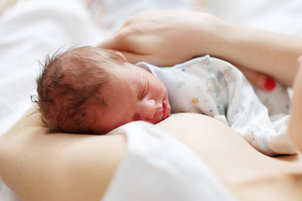 istock One day old newborn baby with mother 957751284