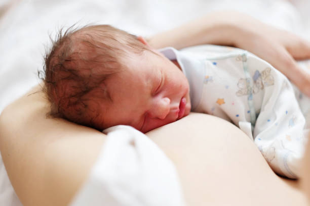 istock One day old newborn baby with mother 957751292