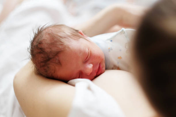 istock One day old newborn baby with mother 957751296