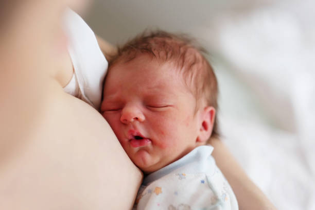 istock One day old newborn baby with mother 957751300