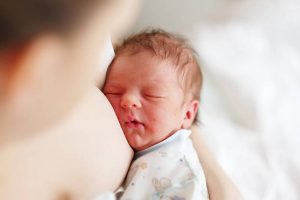 istock One day old newborn baby with mother 957751302