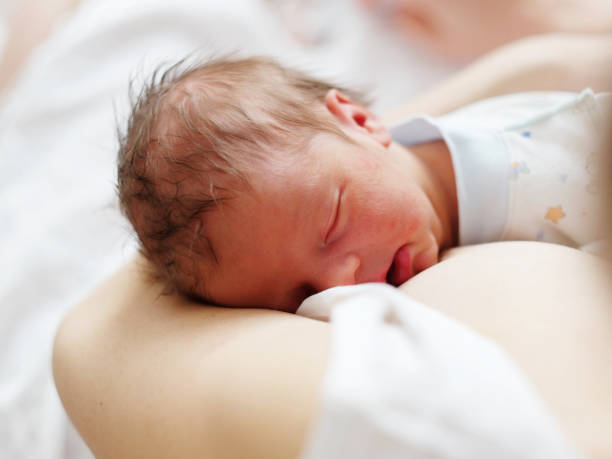 istock One day old newborn baby with mother 957751304