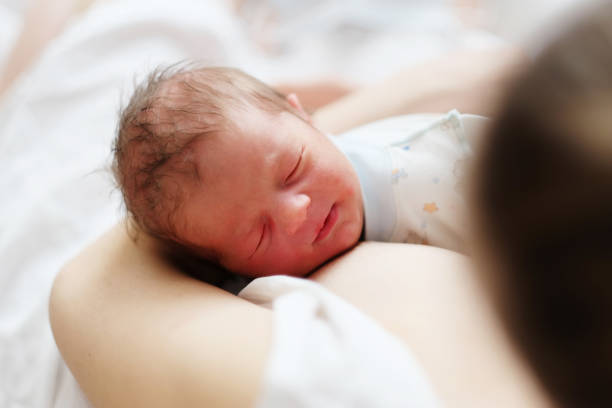 istock One day old newborn baby with mother 957751308