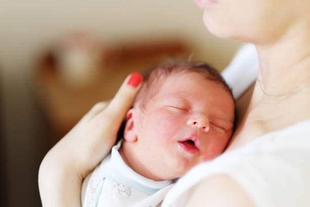 istock One day old newborn baby with mother 957751314