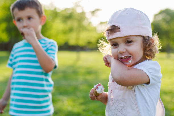 istock girl and boy eating ice cream 957753800