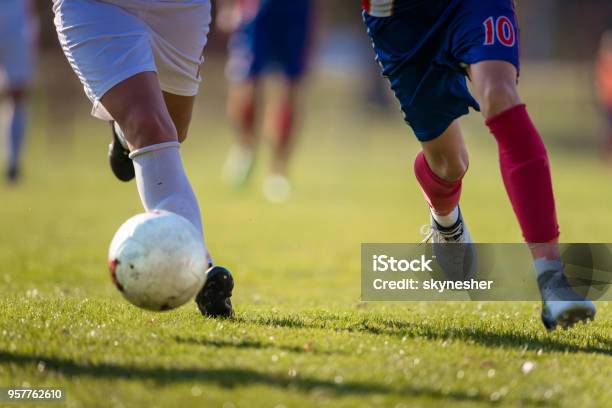 Two Unrecognizable Soccer Players Running With A Ball On A Match Stock Photo - Download Image Now