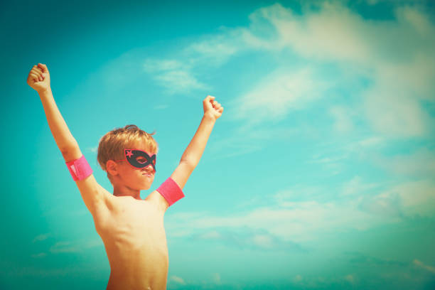 istock little boy play superhero at sky on beach 957762926