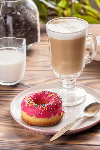 istock Cup of hot coffee latte beverages with donut glazed 957763276