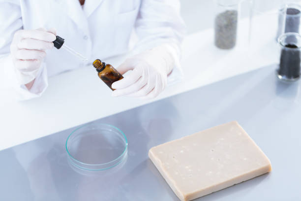 Laborer getting essential oil High angle of laborer getting essential oil for test glass in the laboratory colloid stock pictures, royalty-free photos & images
