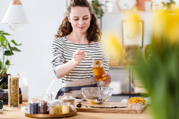 istock Smiling woman pouring honey 957763396