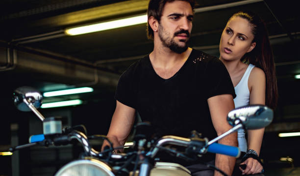 istock Angry girlfriend talking to her biker boyfriend in a garage 957765582