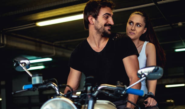 istock Biker man trying to cheer up his angry girlfriend 957765704