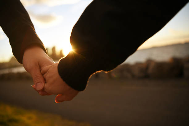 istock Couple hand in hand at sunset 957769082