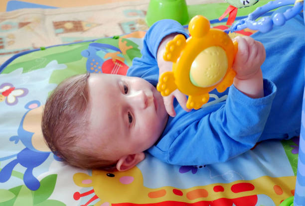 istock Happy baby playing with hanging toys. 957774846