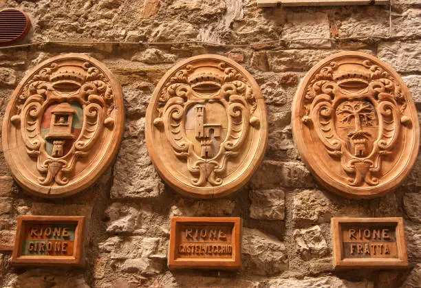 Three faiences tiles of Corciano areas hung on a wall