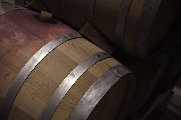 istock Wooden barrel with red wine in dark winery 957782702