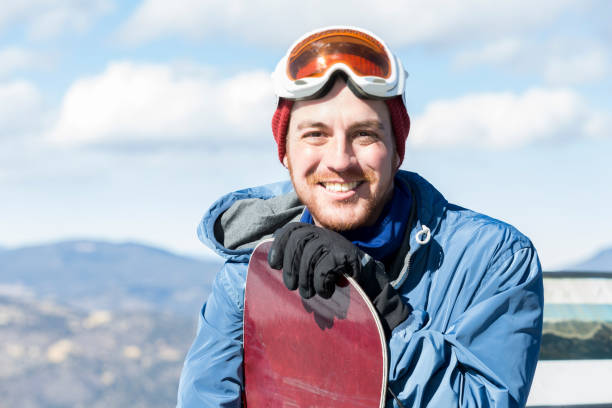 istock Portrait of handsome snowboarder 957786748