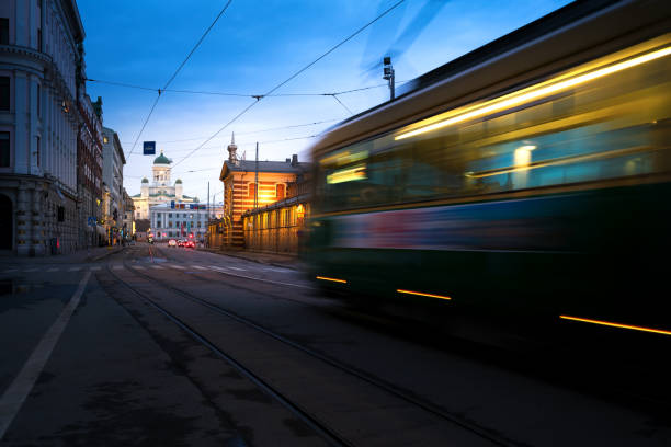 istock Tram passing Helsinki Senate Square during sunset with Helsinki Cathedral in the background at Finland. 957786826