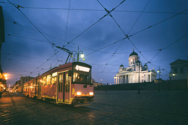 istock Tram passing Helsinki Senate Square during sunset with Helsinki Cathedral in the background at Finland. 957786874