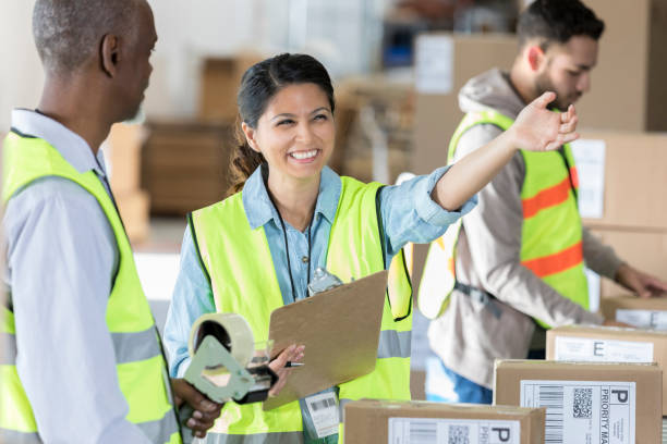 istock Warehouse manager shows something to male employee 957787014