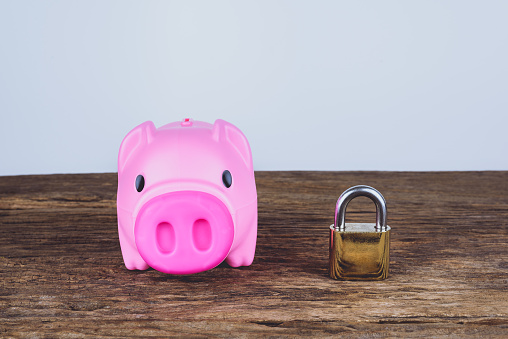 A pink piggybank and lock. Save Money Concept and used for financial protection inferences or other investment messages